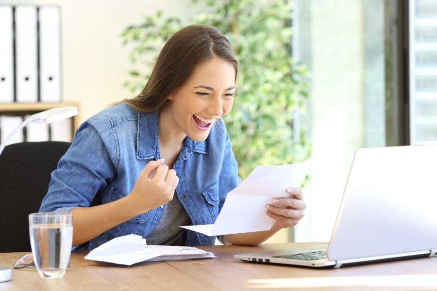 Young woman looking happy about her finances