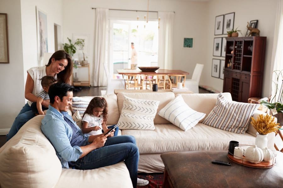 A family with young children together in their living room.