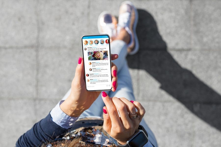 A woman using social media on her phone.