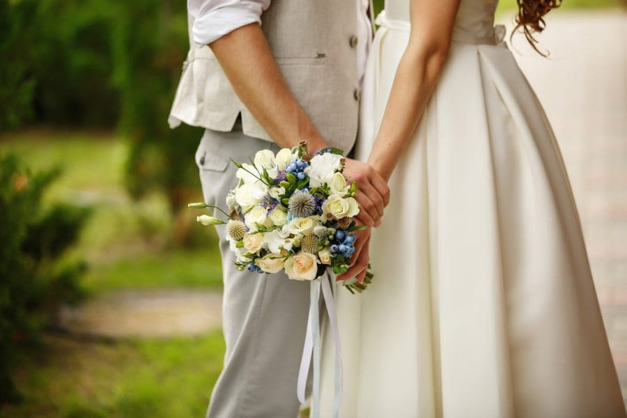 Wedding bouquet in the hands of a bride and groom.