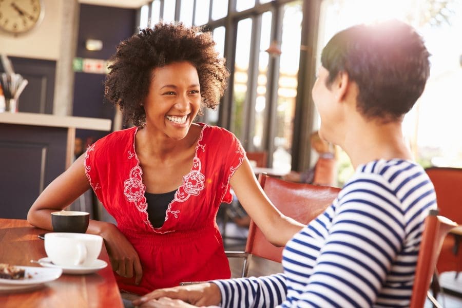 Two women talking over a coffee.