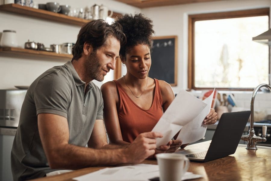 A couple reviewing paperwork in their home.