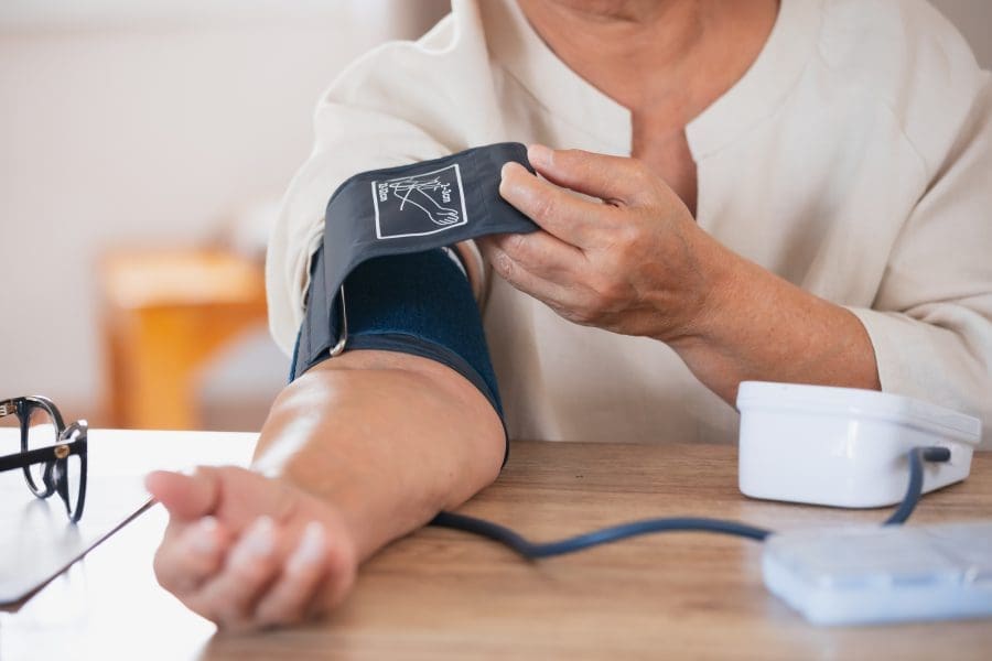 A woman taking her blood pressure.