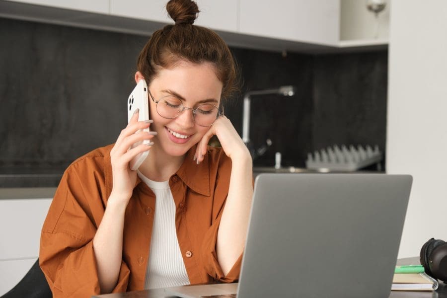 A young woman talking on the phone.