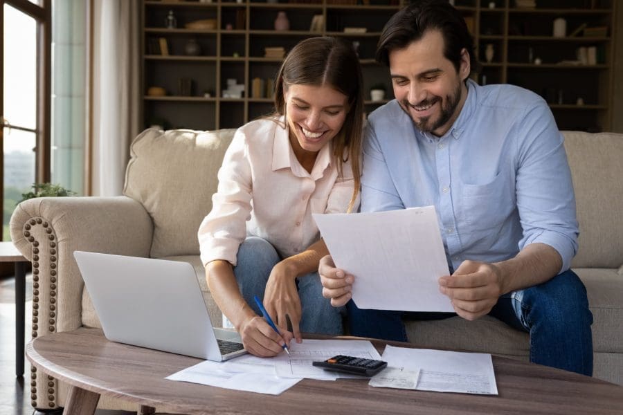 A young couple reviewing paperwork together.