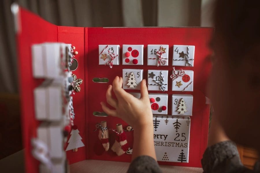 Someone opening a drawer of an Advent calendar.