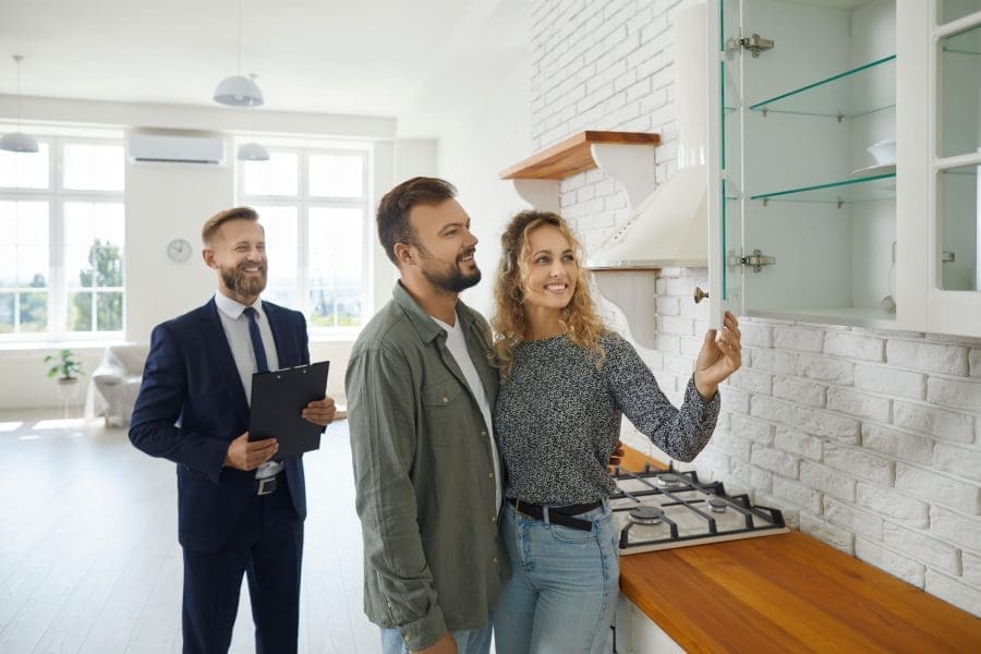 A couple viewing a property with an estate agent.