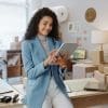 A female business owner using a tablet in an office.