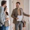 An estate agent showing a couple around a property.