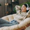 A woman relaxing with headphones on.