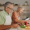 A couple cooking a meal together.
