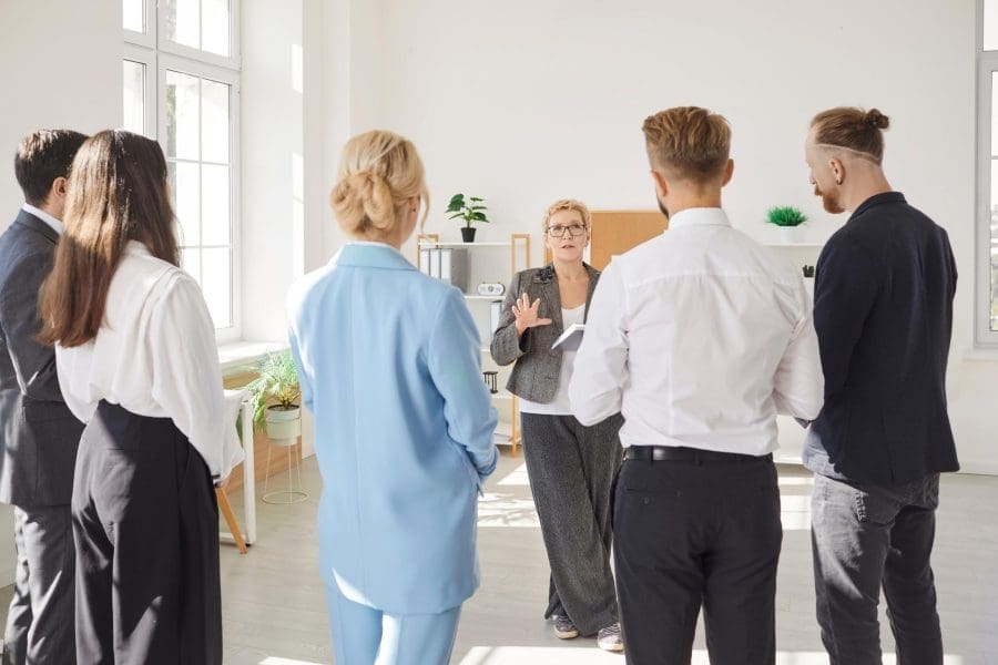 A business owner talking with her employees.