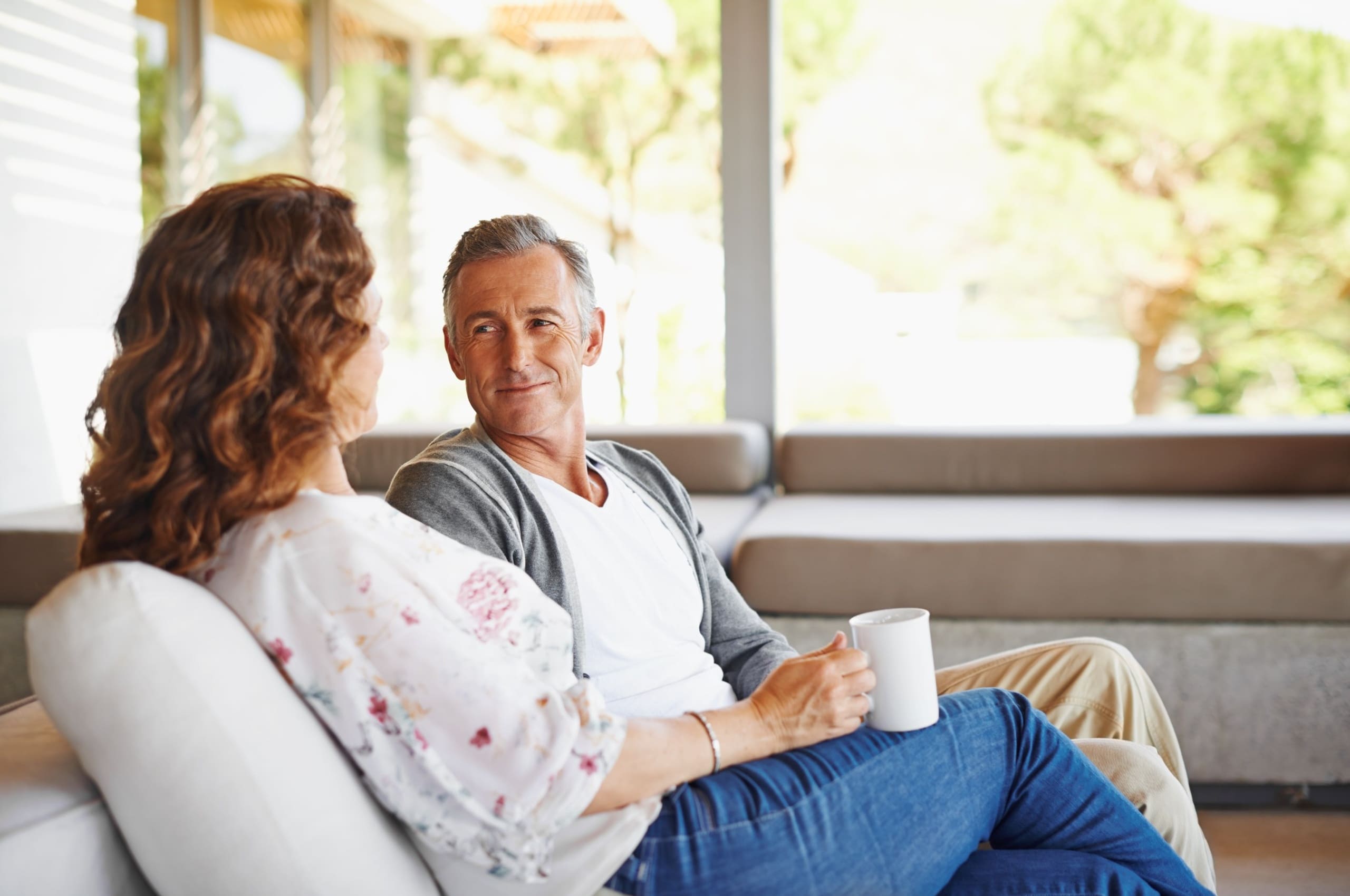 A couple talking in their home.